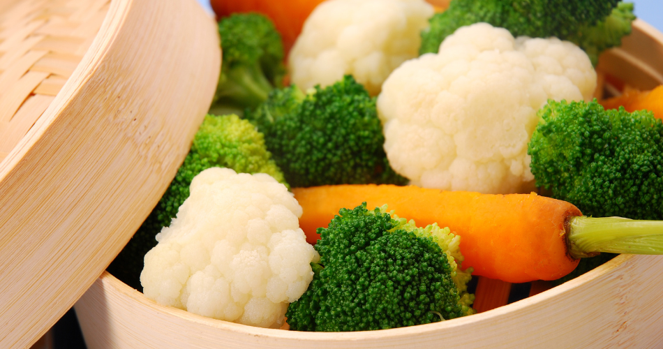 vegetables steaming in a wooden box