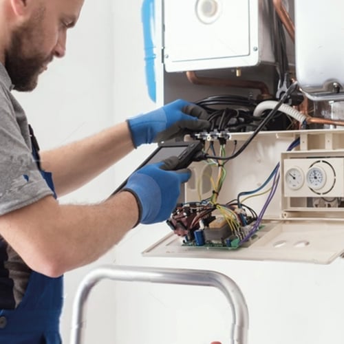 Gas engineer works on a boiler