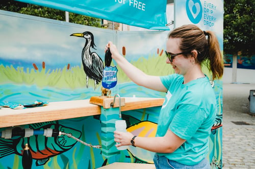 Employee pouring a glass of water