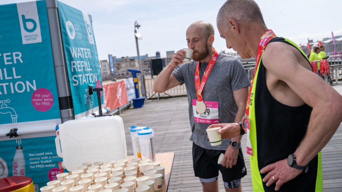 two men drinking water at a race