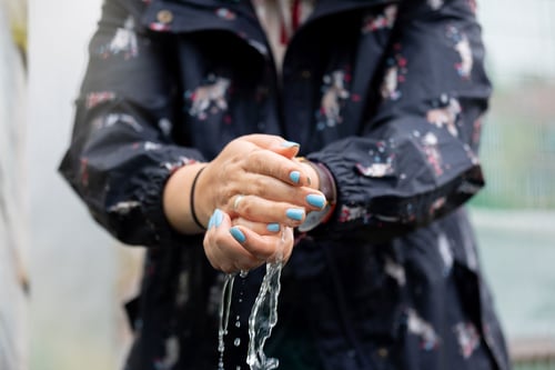 Woman with water on her hands
