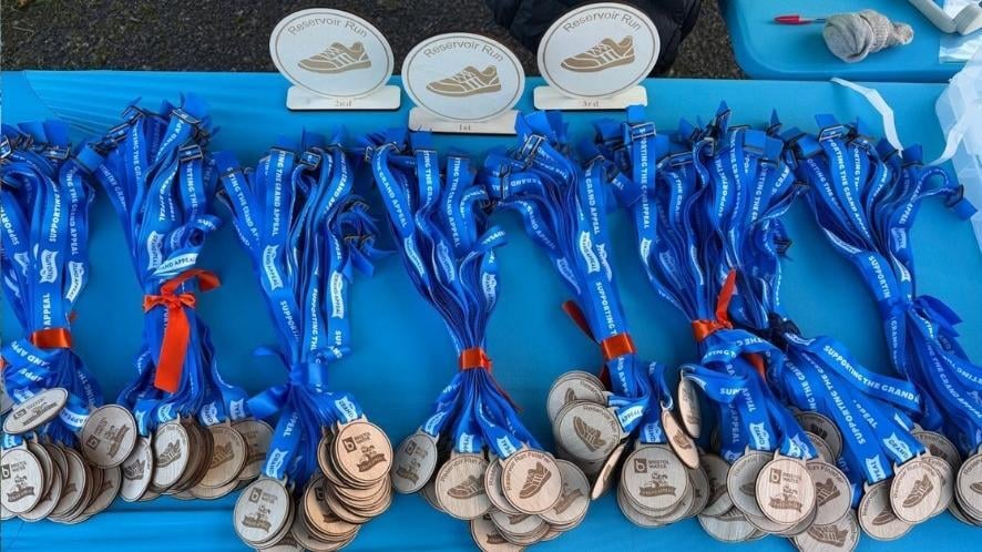 table with the reservoir run medals waiting to be collected
