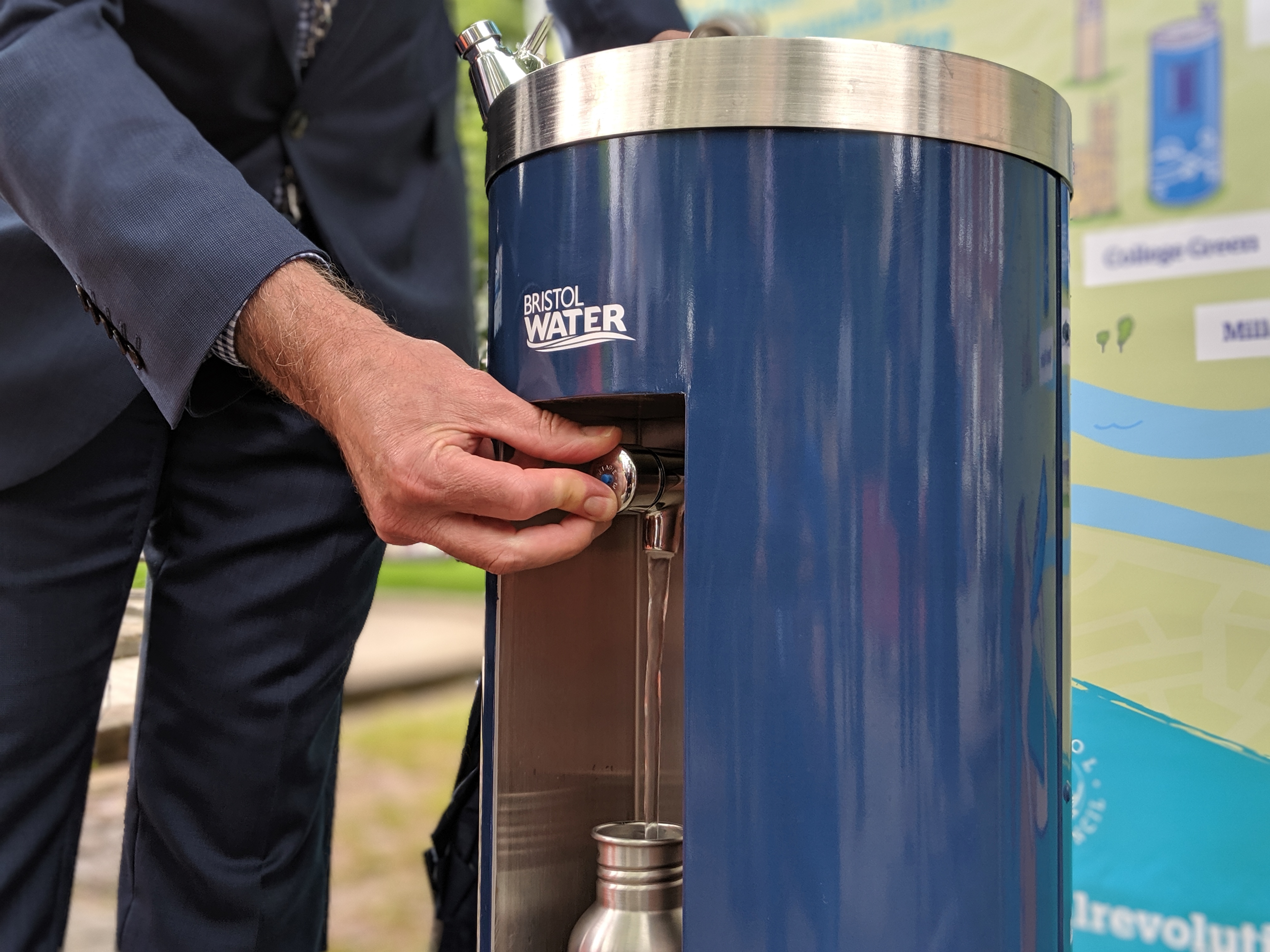 Man refilling a metal water bottle from a Bristol Water fountain
