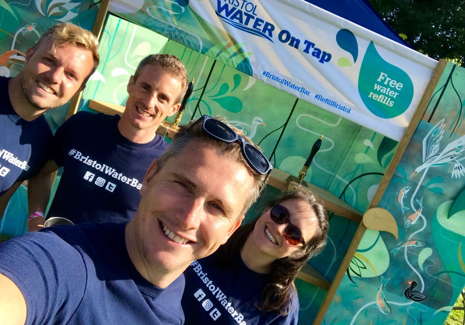Four Bristol Water Workers in front of the free water bar at a festival Four Bristol Water Workers in front of the free water bar at a festival