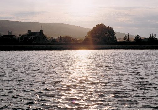 A sunset reflected on the water of Cheddar reservoir 